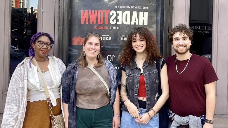 students standing in front of theatre